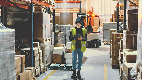 Person taking inventory in warehouse