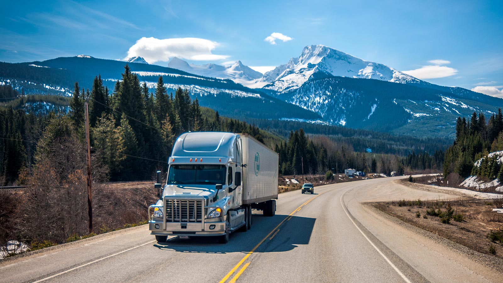 Truck driving on highway with mountains